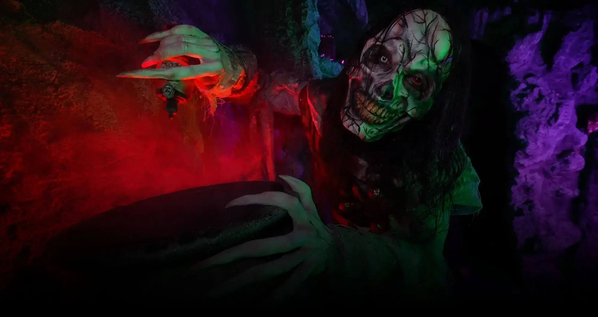 Green-lit ghoul lunges inside Temple of Terror haunt at Bayville Scream Park.