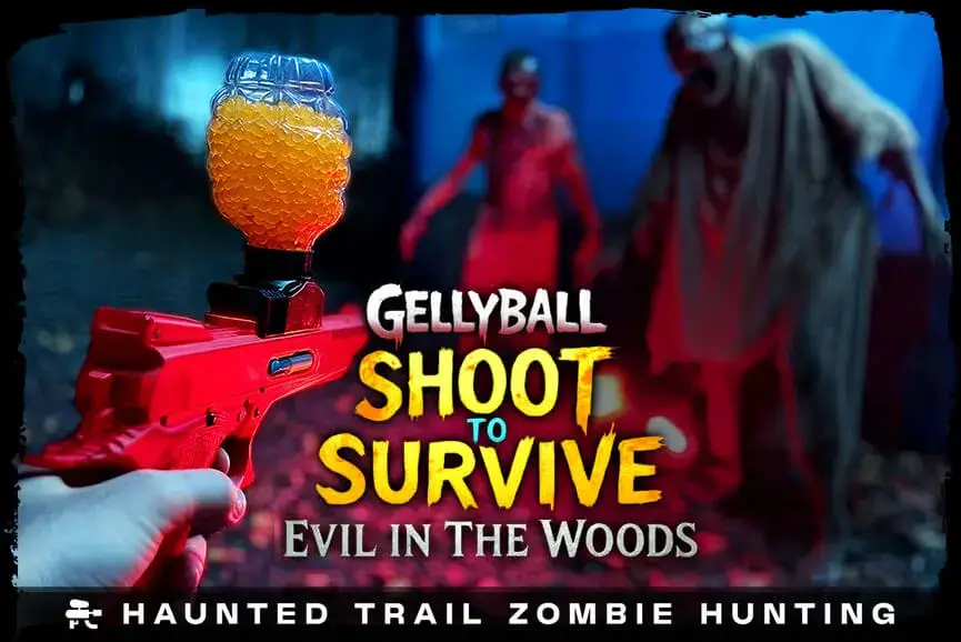 Customer points gelly ball blaster at zombie targets on the Evil in the Woods haunted trail at Bayville Scream Park.