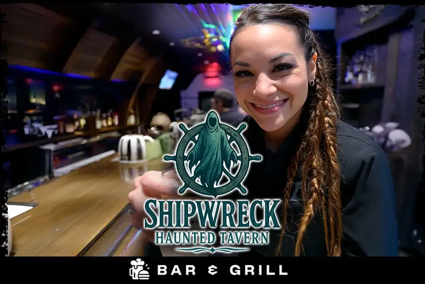 Female bartender hands a drink to a customer inside the Shipwreck-themed bar and grill at Bayville Scream Park's Long Island haunted house event.
