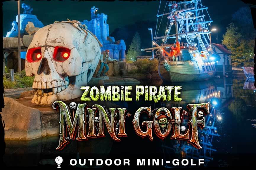 A miniature golf course at night featuring a massive white skull with glowing red eyes next to a large pirate ship replica reflecting on the water. The text reads "Zombie Pirate Mini Golf."